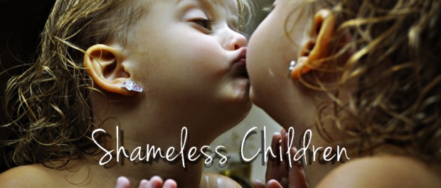 little girl kissing mirror