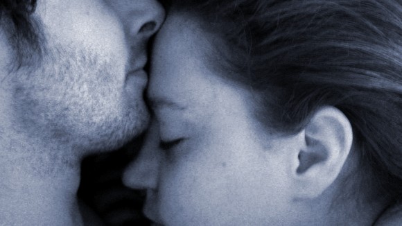 couple cuddling as they sleep