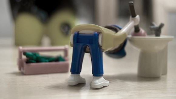 a toy plumber bending over