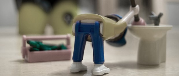a toy plumber bending over
